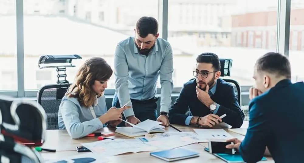 Personas colaborando alrededor de una mesa